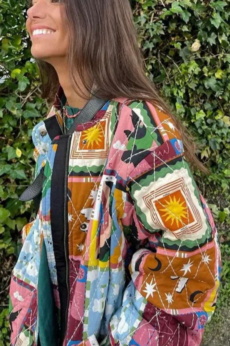 Multi - A woman wearing a vibrant, multi-coloured quilted patchwork jacket over a pink cardigan and white shirt, paired with white trousers.
