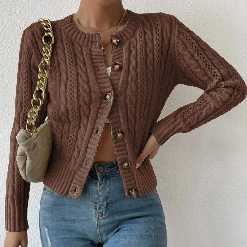 Brown - Women's grey cable knit long sleeve cardigan with tortoiseshell buttons, worn open over a white top and blue jeans.