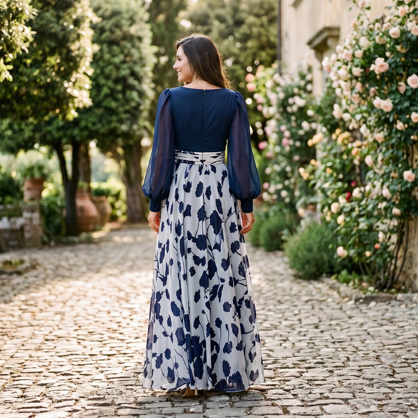 White&Wine Red - A woman posing in a floor-length navy and white floral chiffon maxi dress featuring a deep V-neckline, sheer balloon sleeves, and a 3D floral applique at the waist.