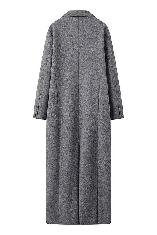 Grey - A woman wearing an oversized, double-breasted maxi coat in textured heather grey wool, featuring wide notched lapels and flap pockets, paired with a matching grey pillbox hat.