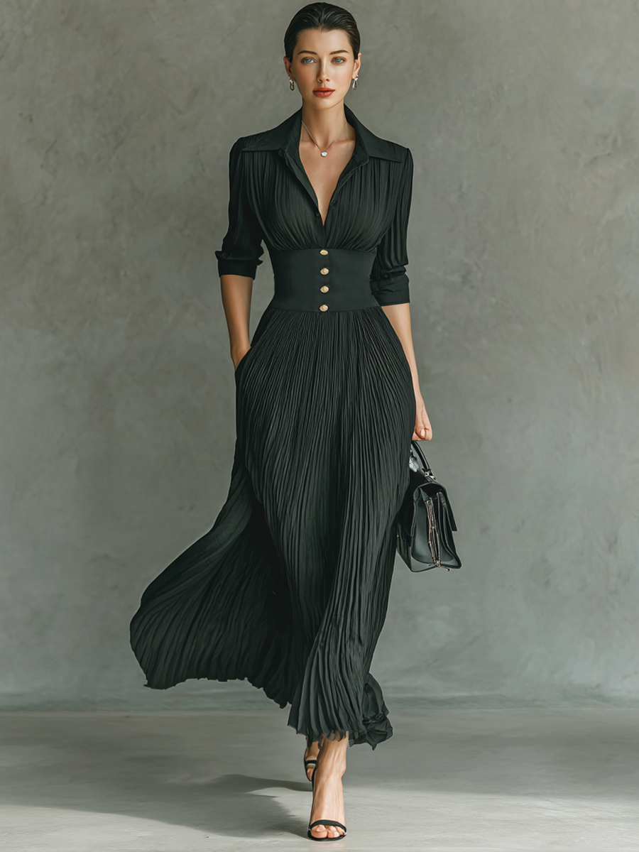 Black - A woman wearing a sophisticated black pleated maxi dress with a structured corset waistband, gold buttons, a spread collar, and elbow-length sleeves.