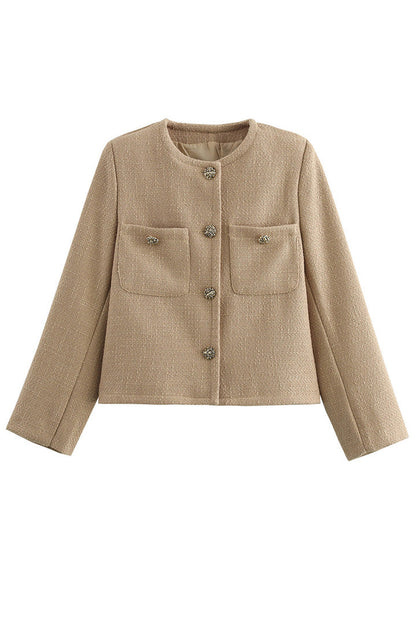 Khaki - Women's smart casual textured cropped jacket in a neutral tone, featuring ornate buttons and a collarless design, styled over a white t-shirt and denim shorts.