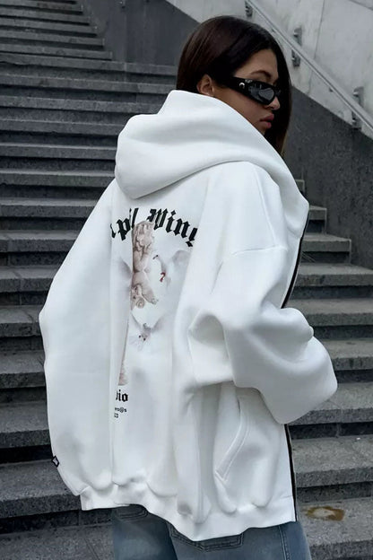 White - Back view of a woman wearing a dark grey oversized hoodie featuring a large graphic print of an angel statue and white doves, paired with a dark grey pleated mini skirt.