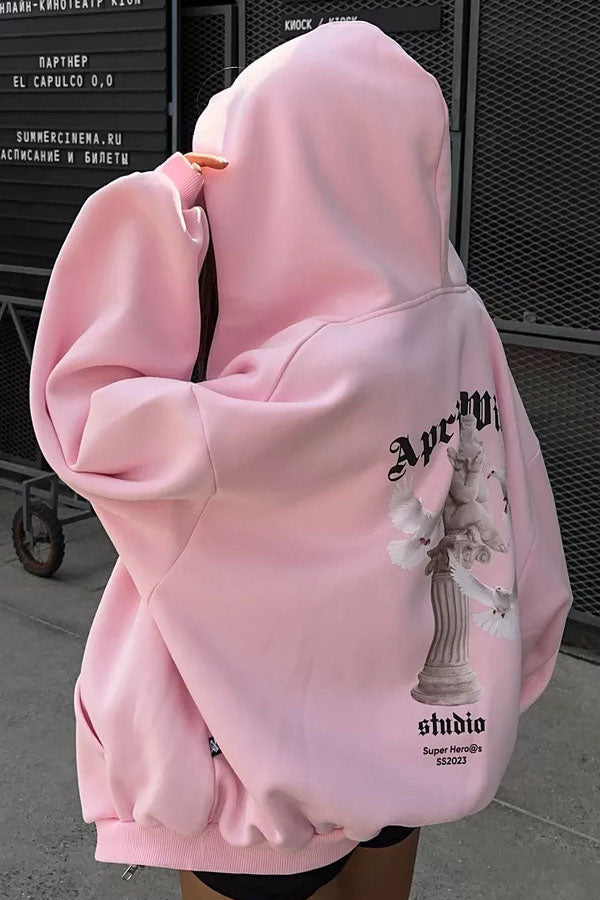 Pink - Back view of a woman wearing a dark grey oversized hoodie featuring a large graphic print of an angel statue and white doves, paired with a dark grey pleated mini skirt.