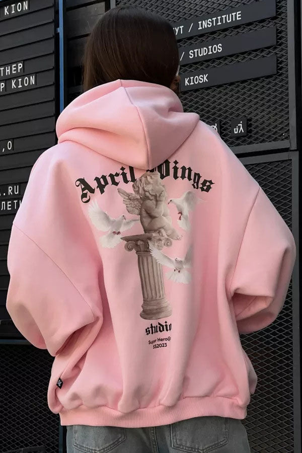 White - Back view of a woman wearing a dark grey oversized hoodie featuring a large graphic print of an angel statue and white doves, paired with a dark grey pleated mini skirt.