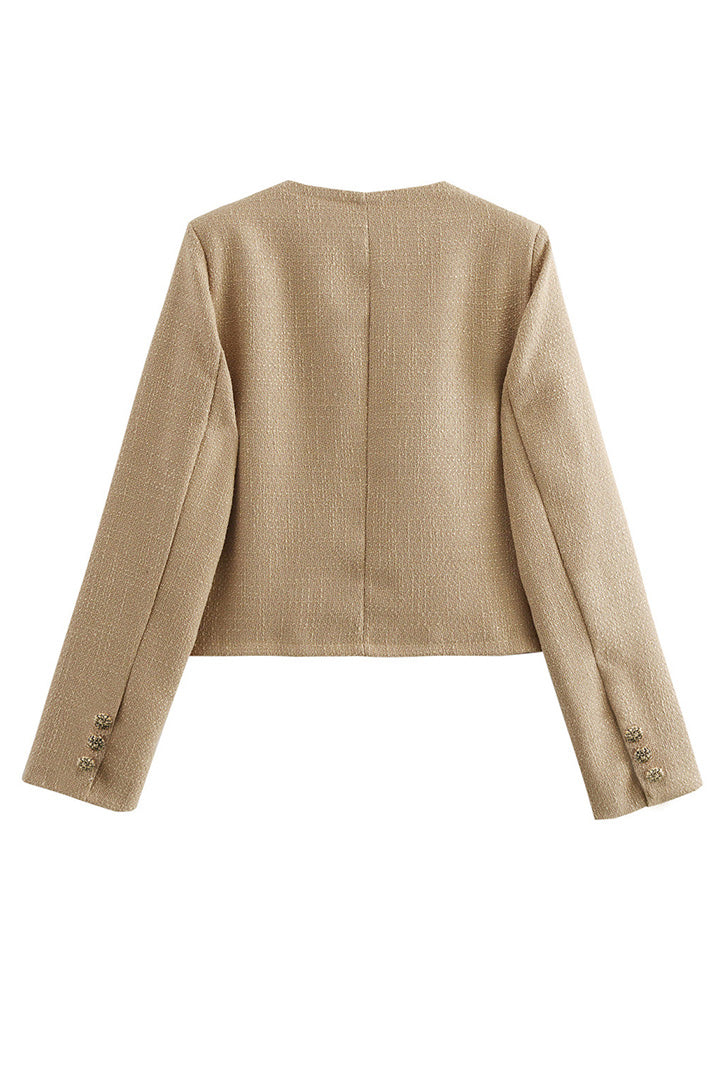 Khaki - Women's smart casual textured cropped jacket in a neutral tone, featuring ornate buttons and a collarless design, styled over a white t-shirt and denim shorts.