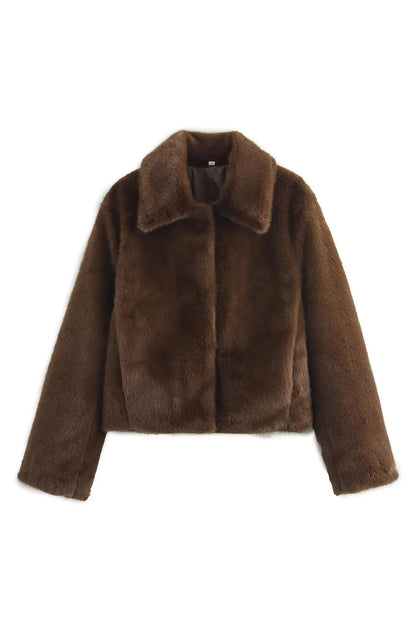 Brown - A woman stands outdoors in an urban setting wearing a plush, dark brown cropped faux fur jacket with a wide collar, styled with a mini skirt and knee-high boots.