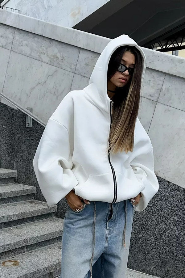 White - Back view of a woman wearing a dark grey oversized hoodie featuring a large graphic print of an angel statue and white doves, paired with a dark grey pleated mini skirt.