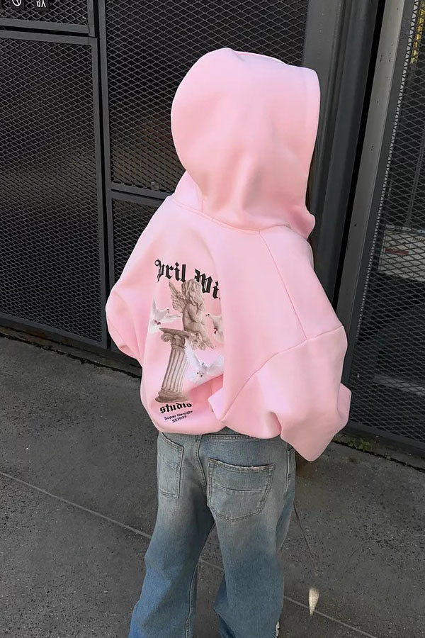 Pink - Back view of a woman wearing a dark grey oversized hoodie featuring a large graphic print of an angel statue and white doves, paired with a dark grey pleated mini skirt.