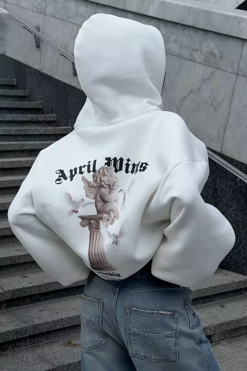 White - Back view of a woman wearing a dark grey oversized hoodie featuring a large graphic print of an angel statue and white doves, paired with a dark grey pleated mini skirt.