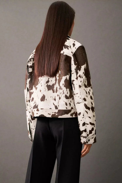 Dairy Cow - Women's cropped button-front jacket featuring a bold cow print pattern, pointed collar, and chest flap pockets.