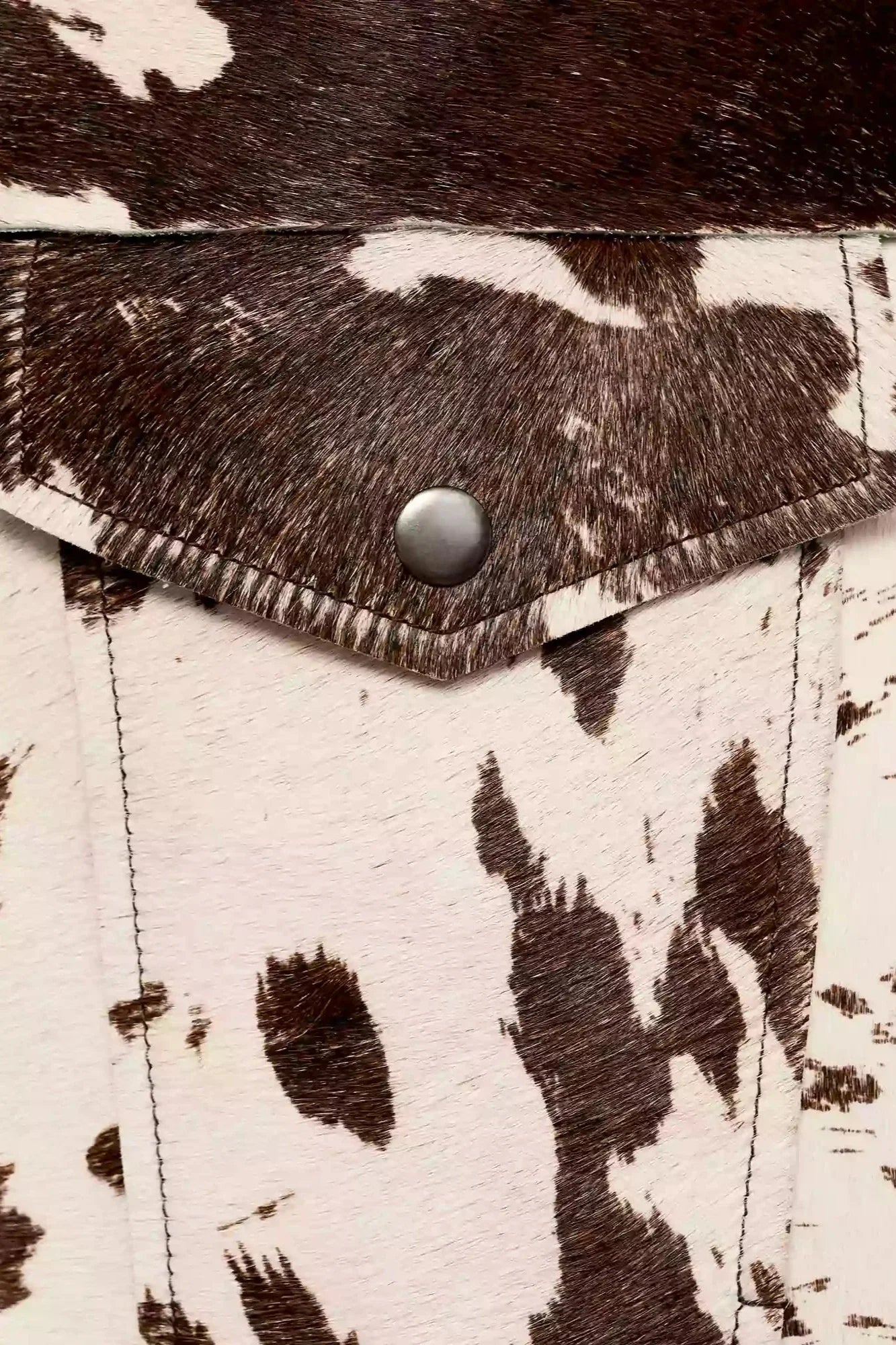 Dairy Cow - Women's cropped button-front jacket featuring a bold cow print pattern, pointed collar, and chest flap pockets.