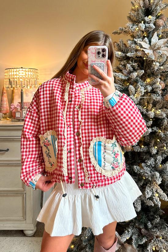 Pink - Women's cropped quilted jacket featuring a red and white gingham pattern, button-front closure, lace trim, and contrast floral heart-shaped patch pockets, worn over a white mini skirt.