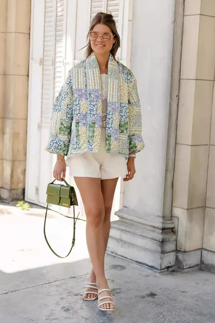Multicolor - Women's relaxed-fit quilted jacket featuring a vibrant patchwork floral print in pastel greens and blues, styled open with contrast edge binding.