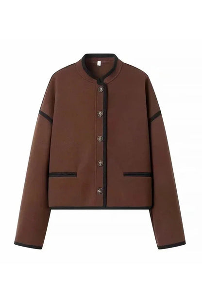 Brown - A woman wearing a dark brown, heavyweight textured cropped jacket with an oversized fit, button-front closure, and dropped shoulders, styled casually with dark denim.