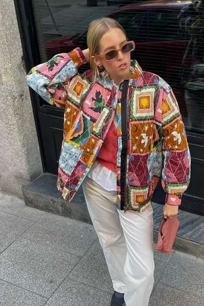 Multi - A woman wearing a vibrant, multi-coloured quilted patchwork jacket over a pink cardigan and white shirt, paired with white trousers.
