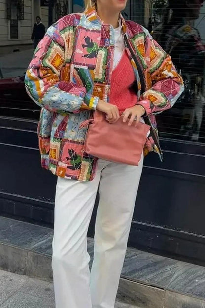 Multi - A woman wearing a vibrant, multi-coloured quilted patchwork jacket over a pink cardigan and white shirt, paired with white trousers.