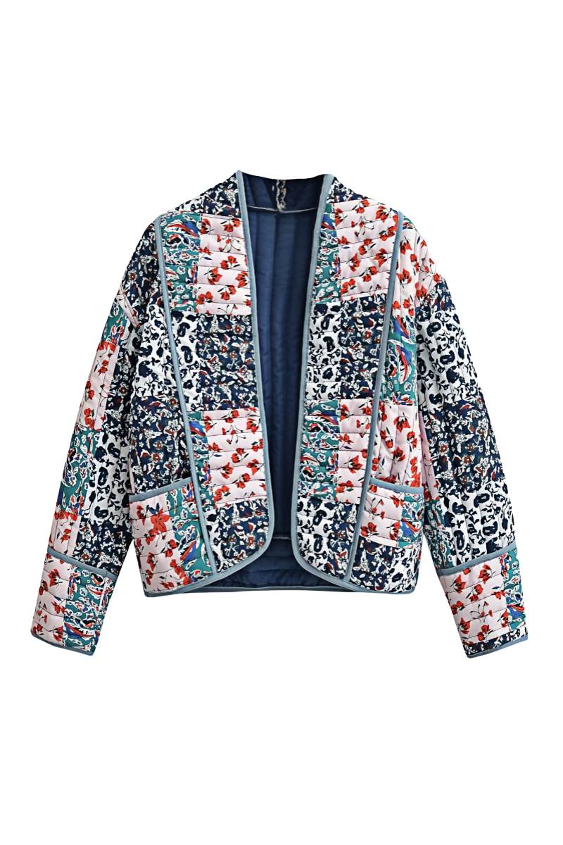 L - Woman wearing a quilted patchwork jacket with floral prints over a white tube top and blue jeans, standing outdoors.