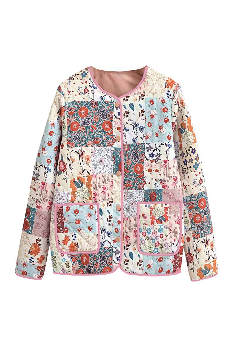 A woman wearing a vibrant, multi-floral patchwork quilted jacket with a collarless neckline and contrast piping, paired with a white skirt.