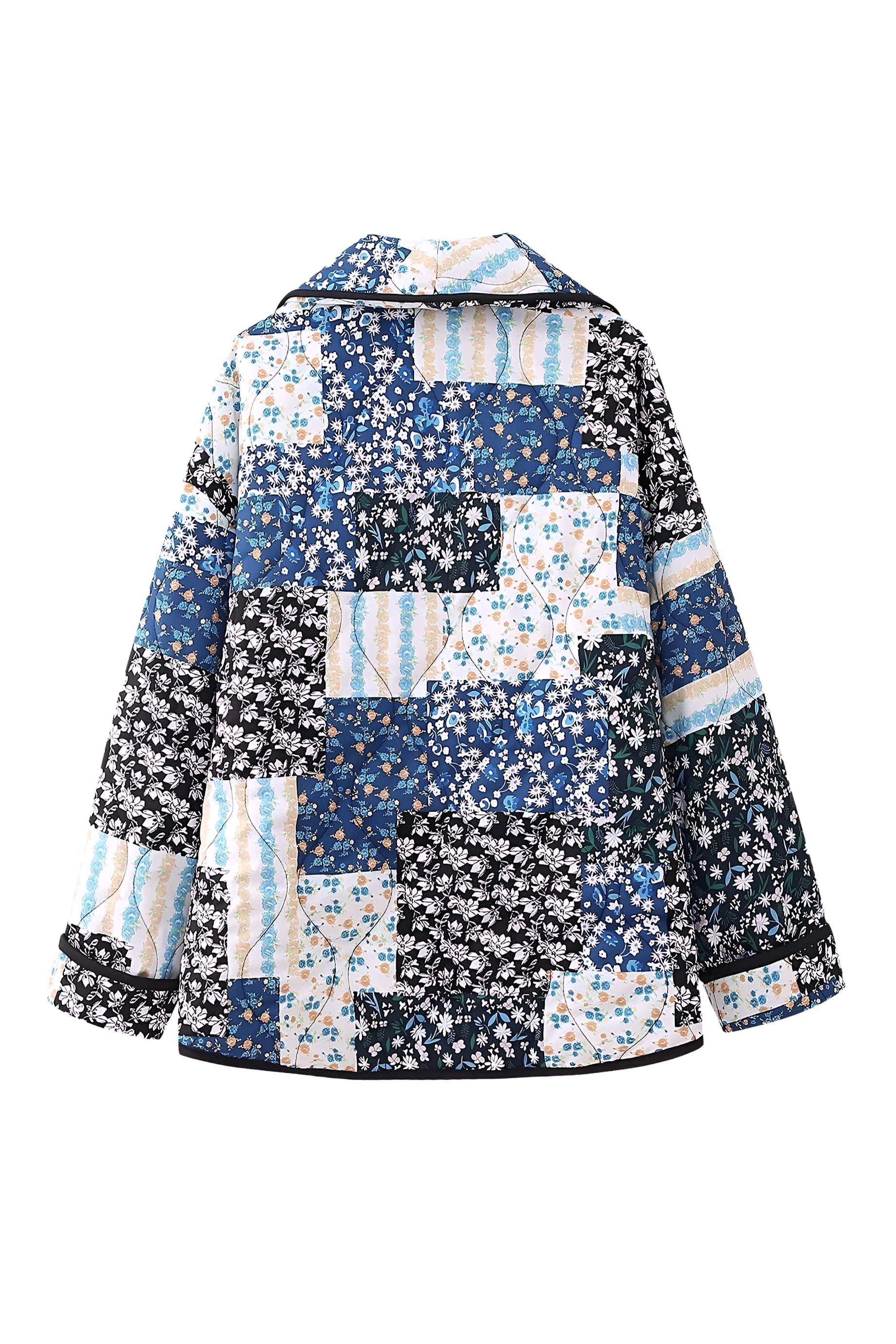 Woman wearing a quilted longline jacket featuring a blue and white floral patchwork design with contrasting dark binding.