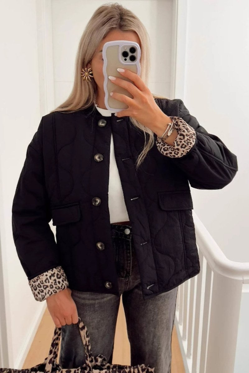 Women's olive green onion quilted jacket featuring a button-front closure, ribbed collar, and rolled cuffs revealing a contrast leopard print lining.