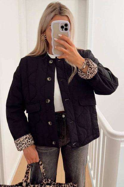 Women's olive green onion quilted jacket featuring a button-front closure, ribbed collar, and rolled cuffs revealing a contrast leopard print lining.