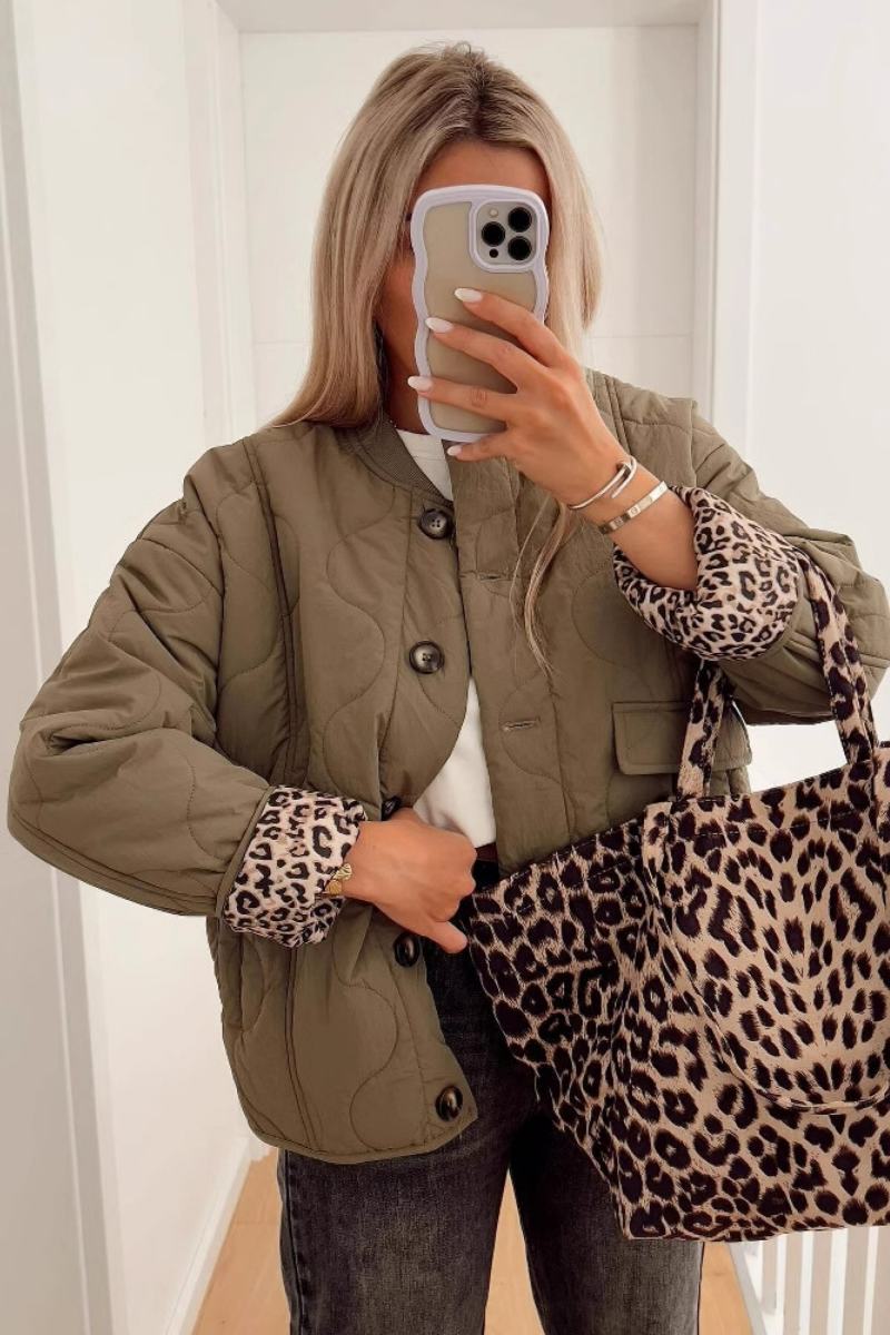 Women's olive green onion quilted jacket featuring a button-front closure, ribbed collar, and rolled cuffs revealing a contrast leopard print lining.