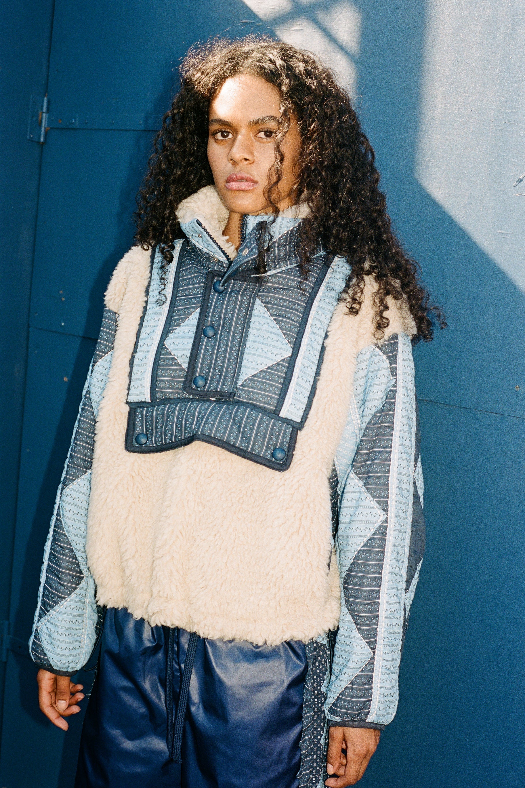 XL - Women's heavyweight pullover jacket featuring a cream fleece bodice, a high snap-button collar, and contrasting blue quilted sleeves with a geometric patchwork print.