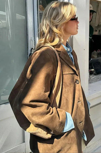 Ligh Brown - Woman wearing a brown longline suede-look jacket over a denim shirt outdoors.