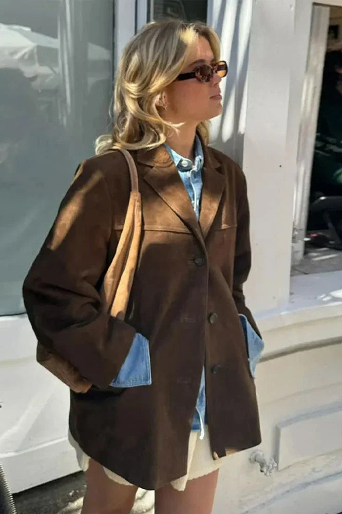 Ligh Brown - Woman wearing a brown longline suede-look jacket over a denim shirt outdoors.