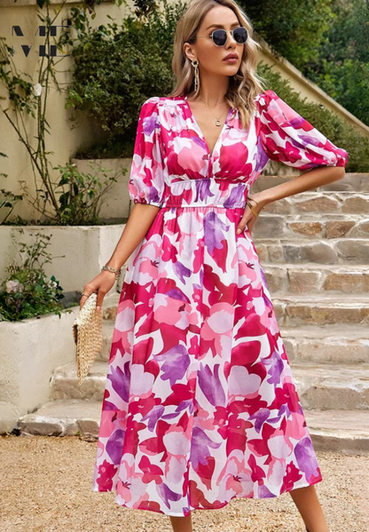 Pink - Women's flowing midi dress featuring a V-neckline, half puff sleeves, and a large-scale abstract floral print in muted earthy tones, styled with a woven clutch.