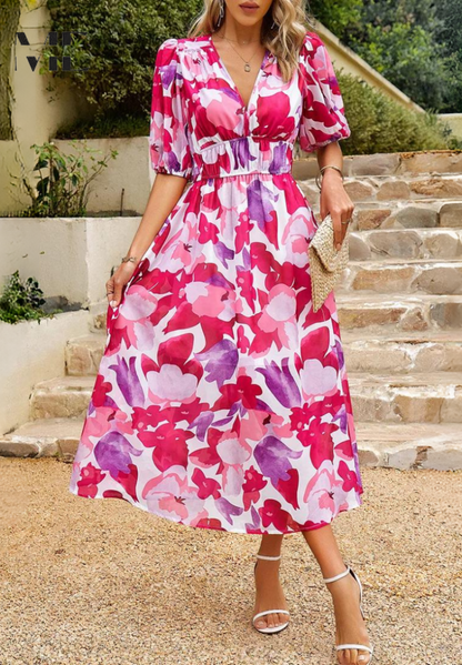 Pink - Women's flowing midi dress featuring a V-neckline, half puff sleeves, and a large-scale abstract floral print in muted earthy tones, styled with a woven clutch.