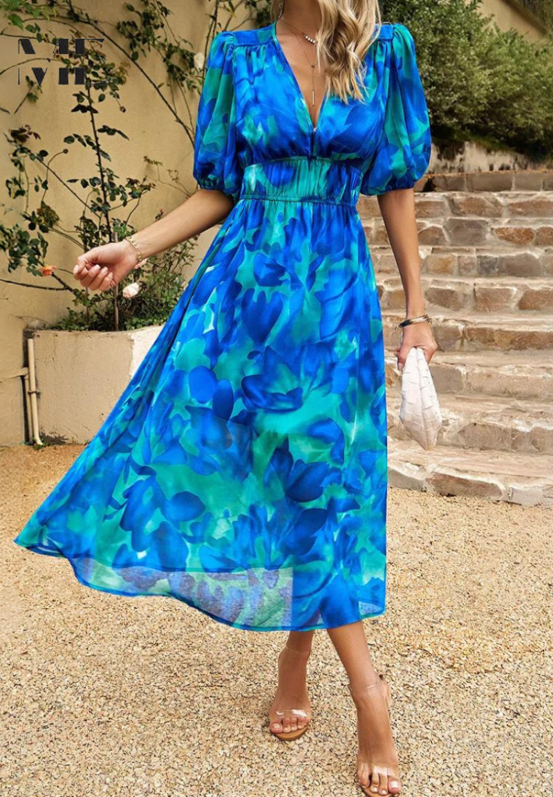 Floral - Women's flowing midi dress featuring a V-neckline, half puff sleeves, and a large-scale abstract floral print in muted earthy tones, styled with a woven clutch.
