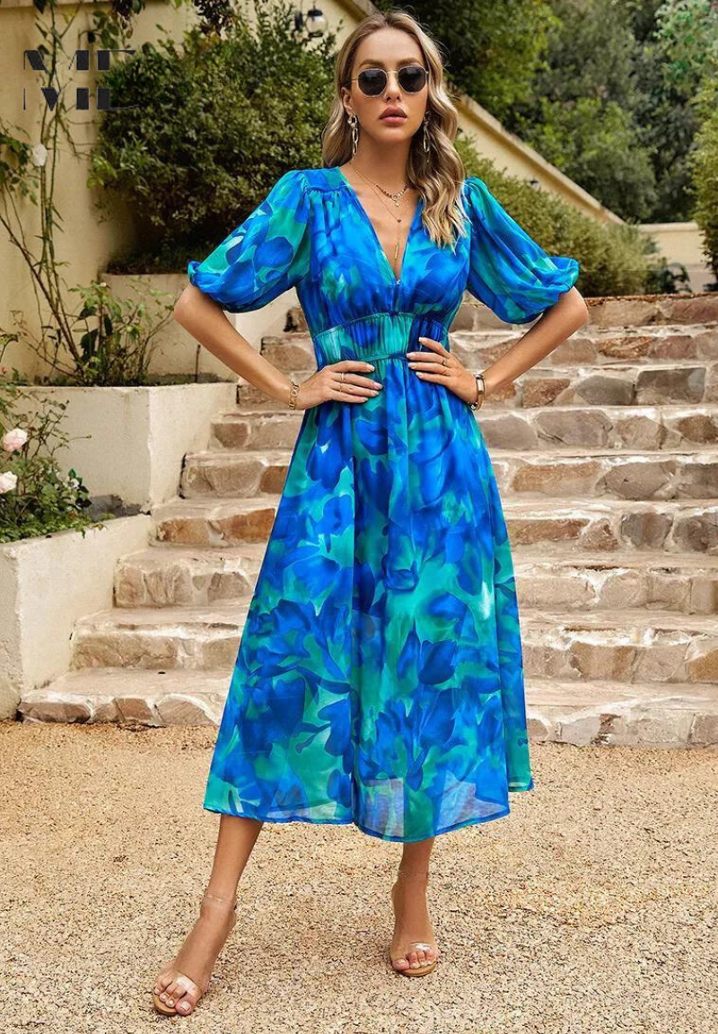 Blue - Women's flowing midi dress featuring a V-neckline, half puff sleeves, and a large-scale abstract floral print in muted earthy tones, styled with a woven clutch.