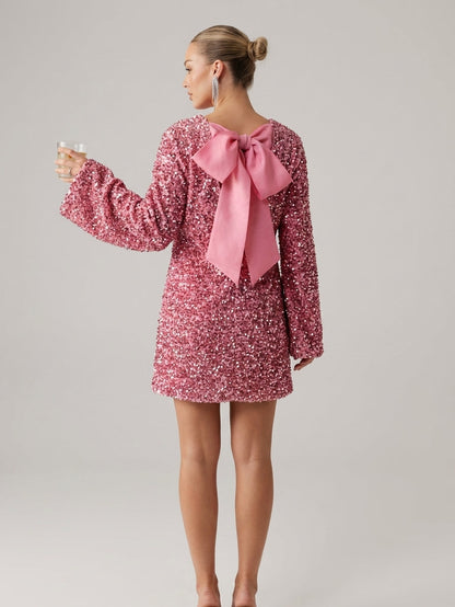 Pink - Model wearing a cream-coloured, highly textured bouclé knit mini dress with a high neckline, long sleeves, and an A-line silhouette, paired with black pointed-toe heels.