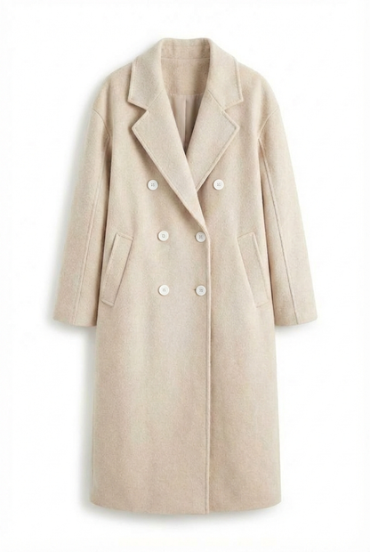Beige - A woman wearing a camel-coloured, double-breasted longline coat with notch lapels and folded cuffs, styled over a striped sweater, blue jeans, and black boots against a white background.