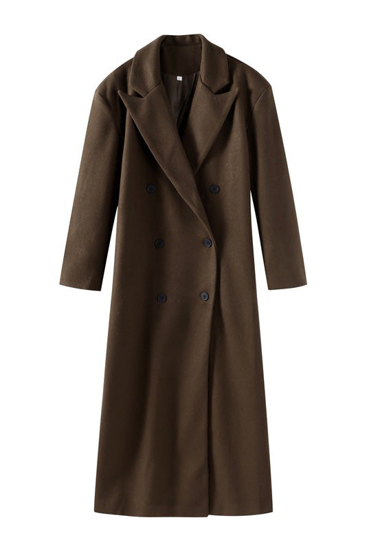 Brown - A person wearing a longline, double-breasted dark chocolate brown overcoat with notch lapels, styled over a beige knit sweater and cream silk skirt.
