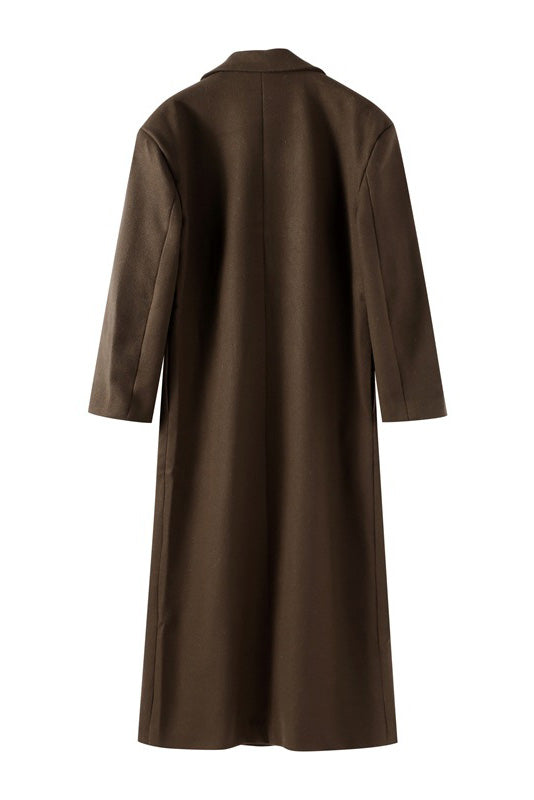 Brown - A person wearing a longline, double-breasted dark chocolate brown overcoat with notch lapels, styled over a beige knit sweater and cream silk skirt.