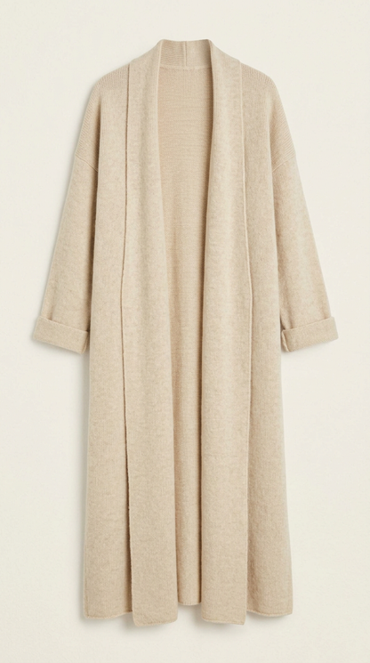 A woman wearing a grey brushed knit longline cardigan with a matching turtleneck and skirt, showcasing a minimalist, monochromatic look.