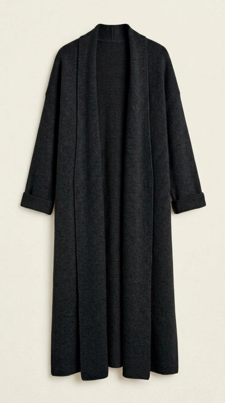 A woman wearing a grey brushed knit longline cardigan with a matching turtleneck and skirt, showcasing a minimalist, monochromatic look.