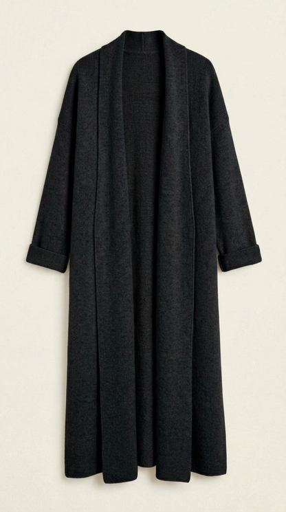 A woman wearing a grey brushed knit longline cardigan with a matching turtleneck and skirt, showcasing a minimalist, monochromatic look.