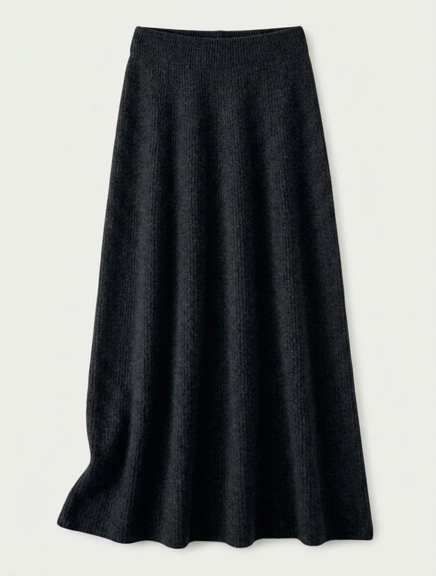 A woman wearing a grey brushed knit longline cardigan with a matching turtleneck and skirt, showcasing a minimalist, monochromatic look.