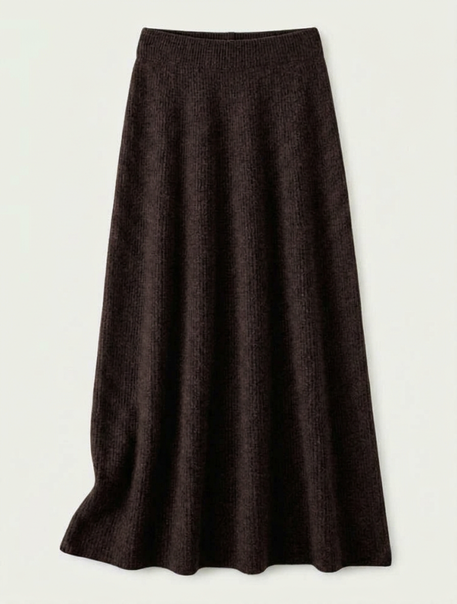 A woman wearing a grey brushed knit longline cardigan with a matching turtleneck and skirt, showcasing a minimalist, monochromatic look.
