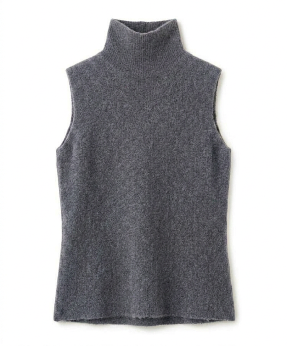 A woman wearing a grey brushed knit longline cardigan with a matching turtleneck and skirt, showcasing a minimalist, monochromatic look.