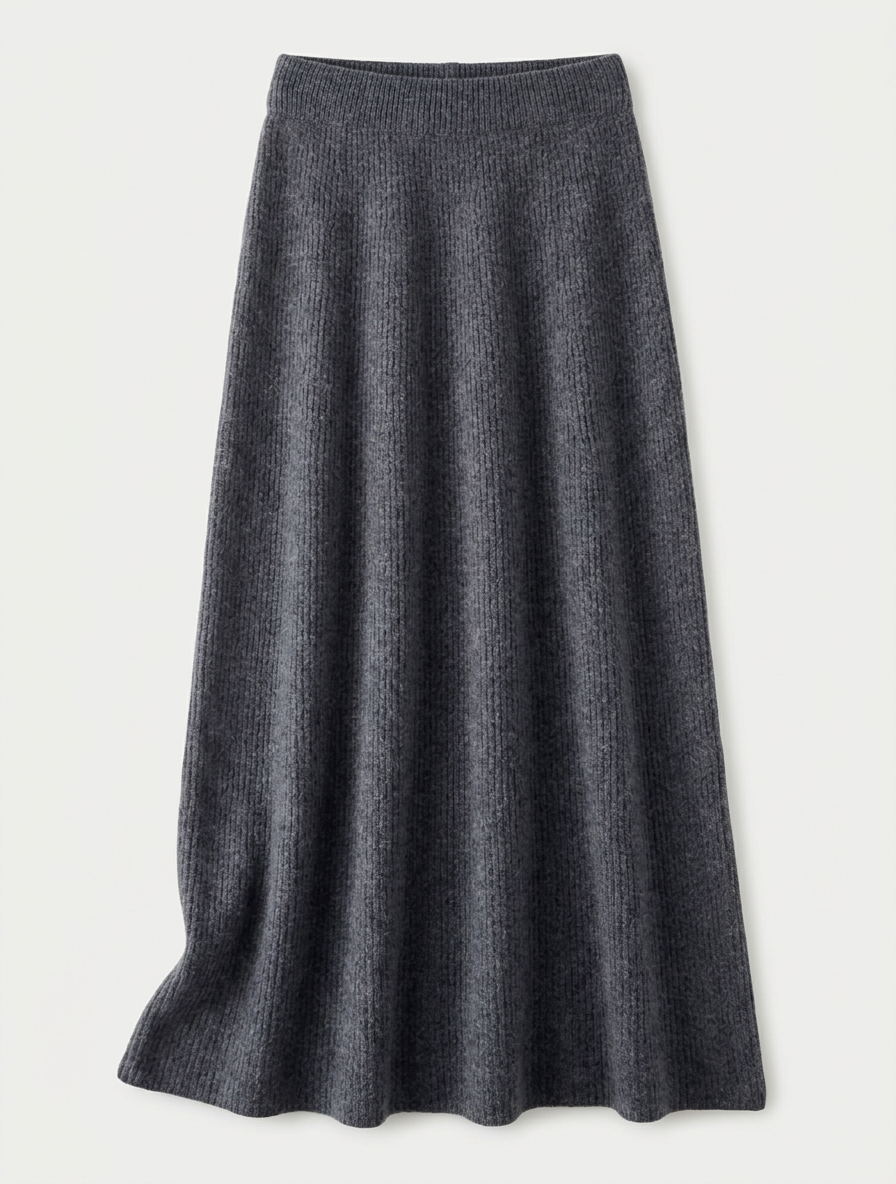 A woman wearing a grey brushed knit longline cardigan with a matching turtleneck and skirt, showcasing a minimalist, monochromatic look.
