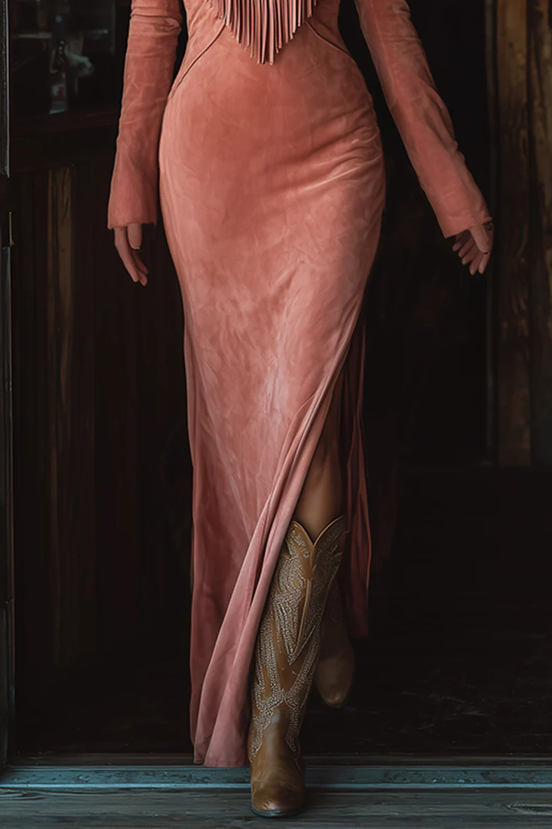 Pink - A woman wearing a dusty rose brushed suede maxi dress featuring western-style embroidery, a V-shaped fringe yoke, long sleeves, and a high leg slit, paired with embroidered cowboy boots.
