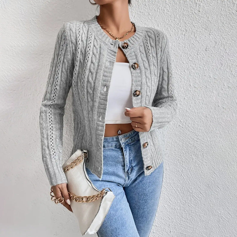 Gray - Women's grey cable knit long sleeve cardigan with tortoiseshell buttons, worn open over a white top and blue jeans.