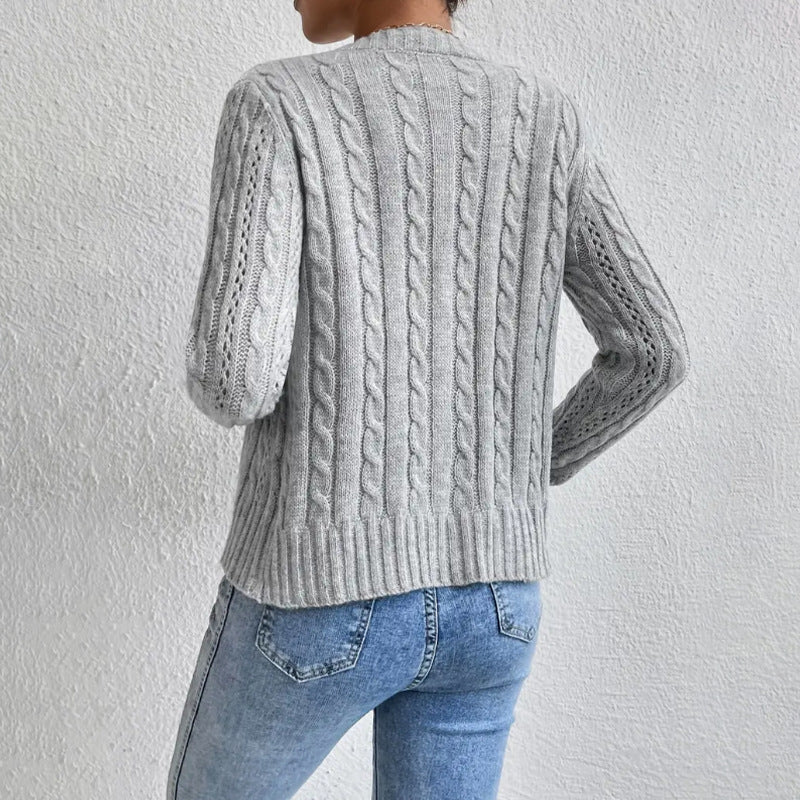 Apricot - Women's grey cable knit long sleeve cardigan with tortoiseshell buttons, worn open over a white top and blue jeans.