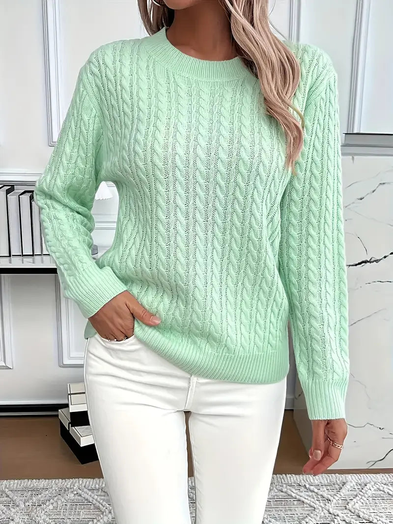 Light Green - Women's light pink cable knit sweater with long sleeves and a crew neckline, worn with white pants.