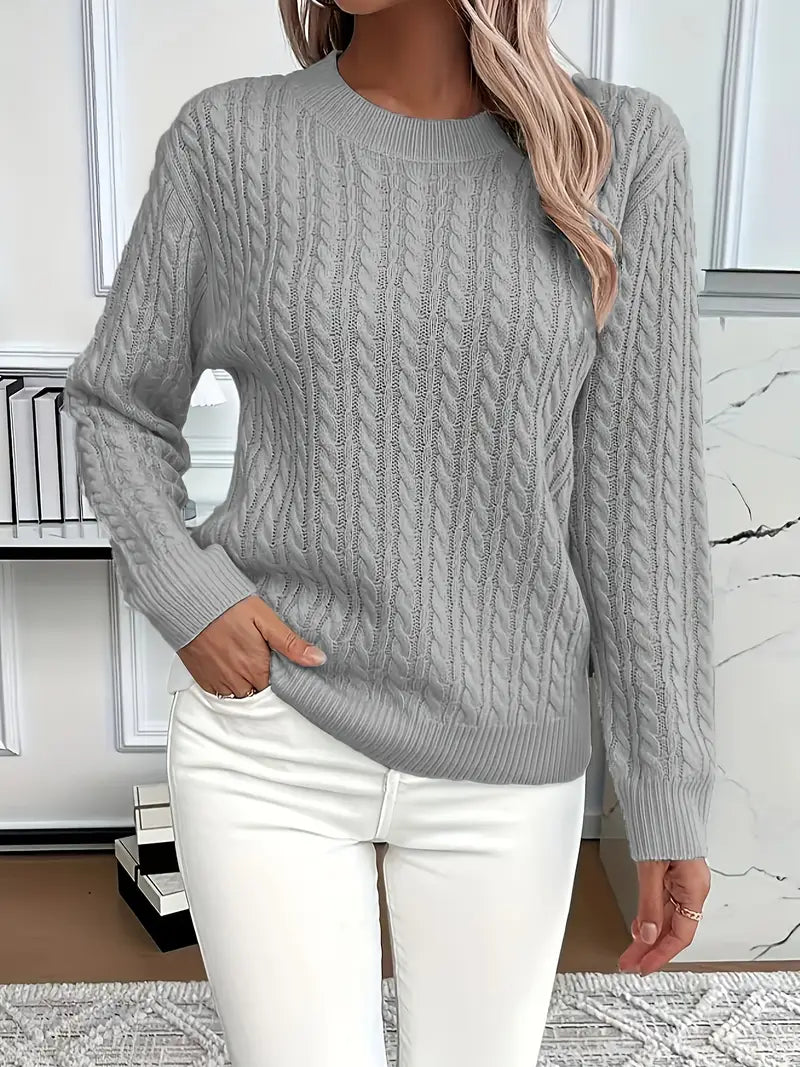 Grey - Women's light pink cable knit sweater with long sleeves and a crew neckline, worn with white pants.